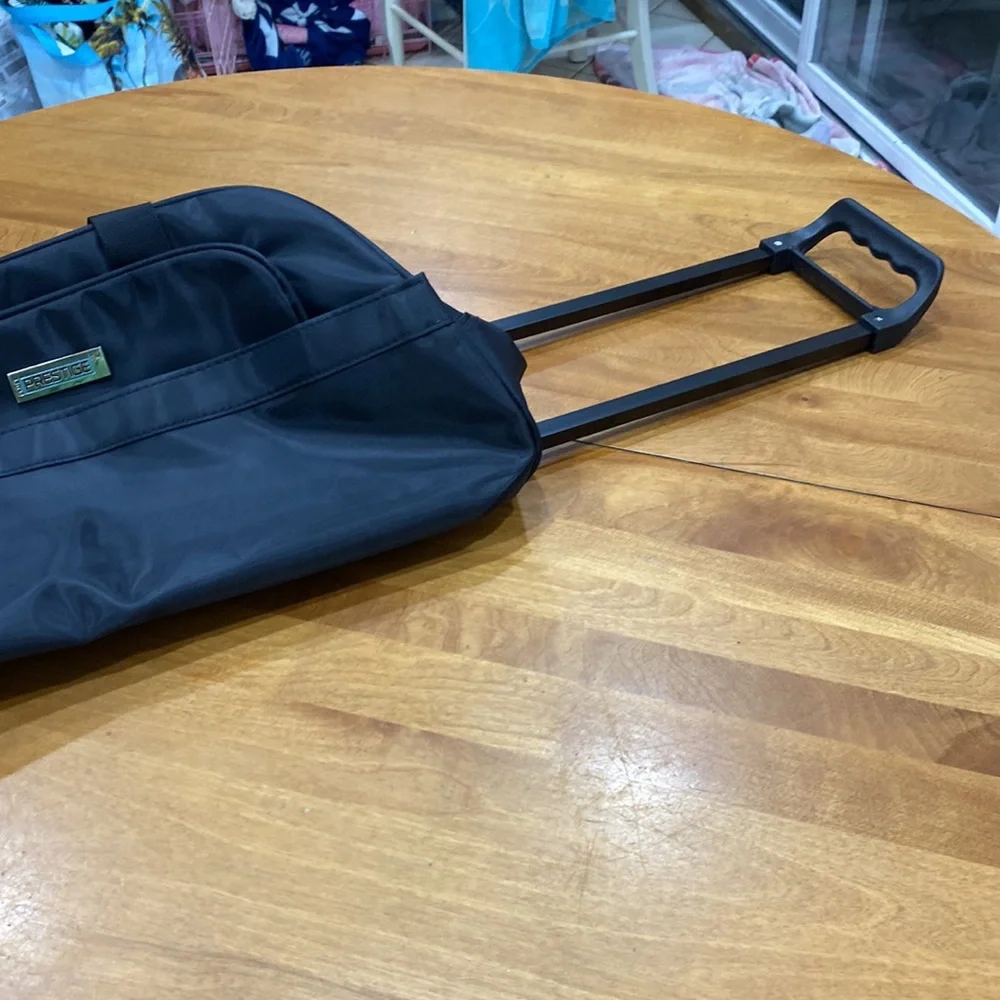 NWOT. Nylon rolling carry-on bag.